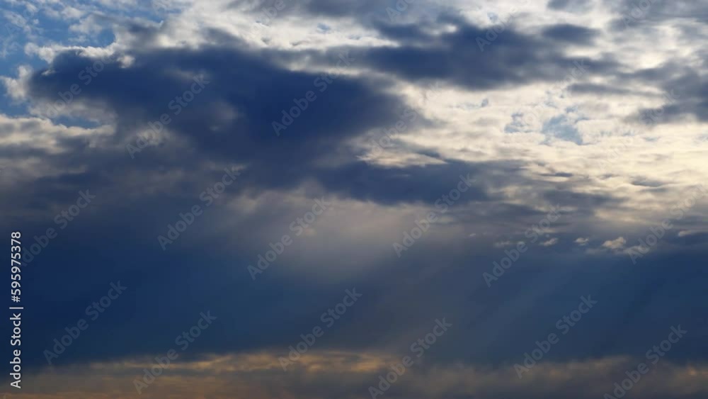 Sky with dark clouds and orange light from the sun at sunrise.