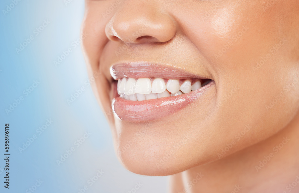 Never hide a smile so beautiful. Closeup shot of an unrecognizable woman smiling against a blue background. Never hide a smile so beautiful. Closeup shot of an unrecognizable woman smiling against a blue background.
