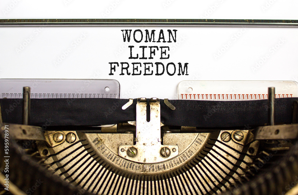 Woman life freedom symbol. Concept words Woman Life Freedom typed on an old retro typewriter on a beautiful white paper background. Social issue woman life freedom concept. Copy space.