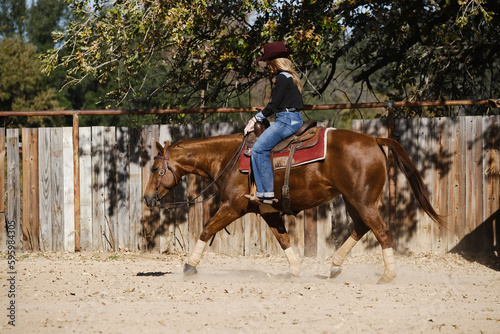 Cowgirl riding in outdoor arena, western industry lifestyle in Texas.