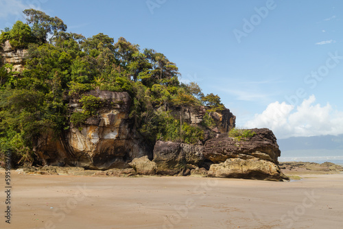 Cliff in Bako national park, sunny day, blue sky and sea. Vacation, travel, tropics concept