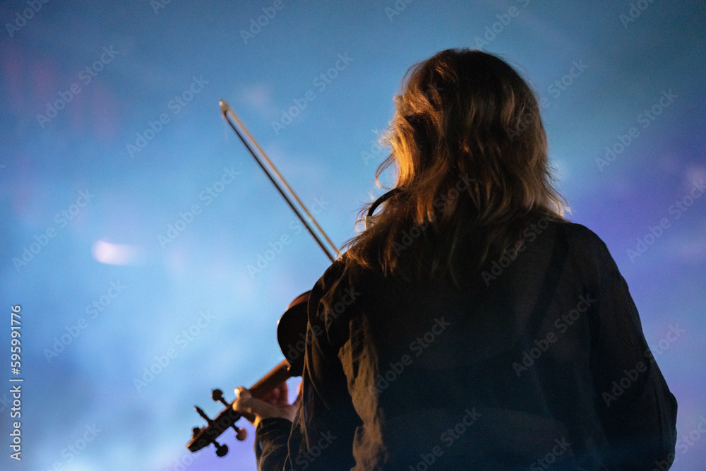 Band playing music and a gig in a venue, close up of a rock band playing guitars and instruments. Band playing music and a gig in a venue, close up of a rock band playing guitars and instruments.