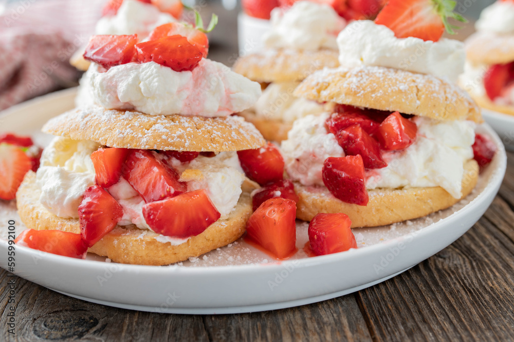 Strawberry cake with whipped cream. Traditional shortcakes with marinated strawberries. Strawberry cake with whipped cream. Traditional shortcakes with marinated strawberries.