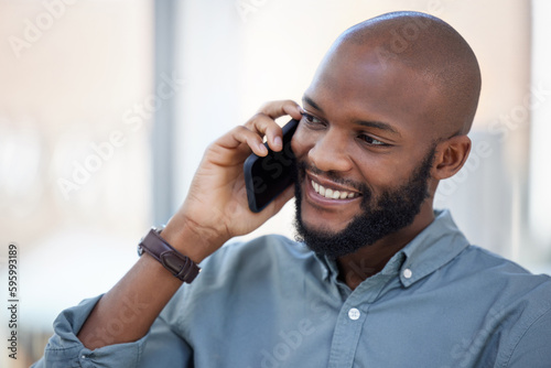 Chase your dreams. a young businessman using a smartphone in a modern office.