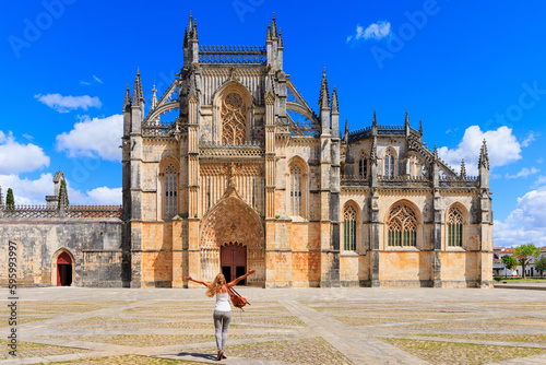 Woman tourist in front of The Monastery of Batalha- Portugal, Leiria- 2023 photo