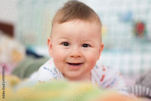 Portrait of cute happy baby boy looking at camera. Joy and happiness concept. Love and family emotion