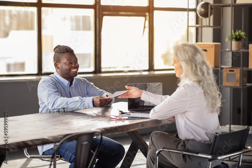 Fotografija Headhunter Man Talking With Employee Woman Giving Paper In Office