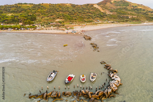 Karpen, Albania - August 12, 2022. Small boats moored in shallow water