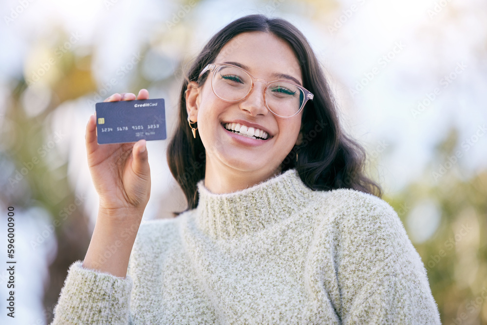 I made the smart choice. a happy young woman holding up a credit card while standing outside. - obrazy, fototapety, plakaty 