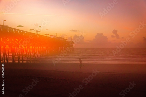 Man jogging on beach at sunrise- Garden City Myrtle Beach South Carolina summer 2022