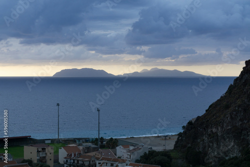 vulcano island on cloudy sunset blue sky viewed from milazzo mountains