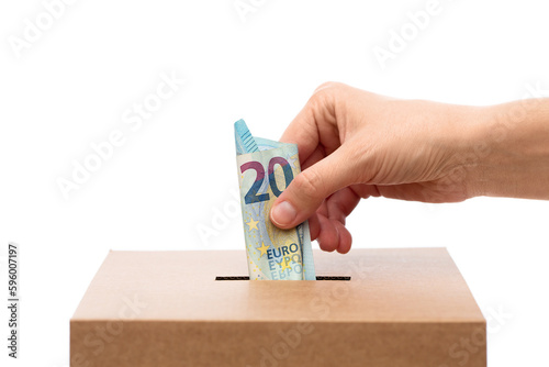 Photography charity, savings and fundraising concept - close up of hand putting euro cash mo