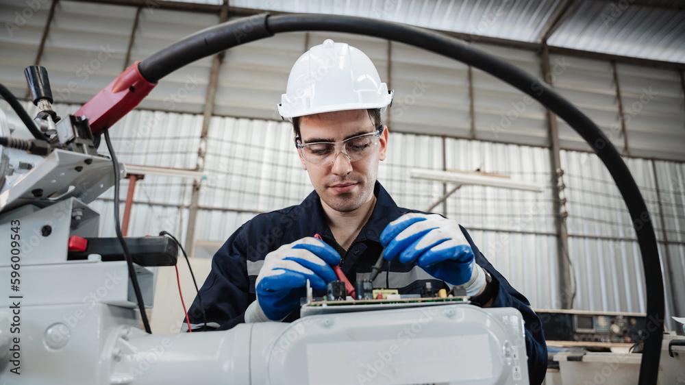 Industrial engineers are in charge of controlling the automated robot arms machine welding robots in industrial manufacturing factory. Industrial engineers are in charge of controlling the automated robot arms machine welding robots in industrial manufacturing factory.