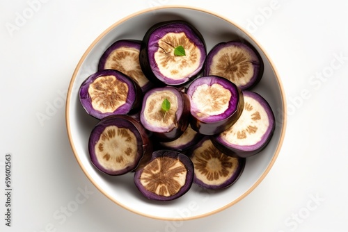 Fresh eggplant in a white bowl. View from top. Ingredients for juice, salad, dishes, cuisine.  