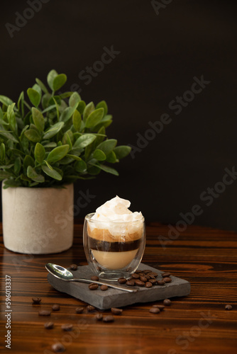 coffee-based drink on a table with a plant in the background