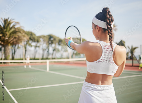 I know exactly where I want this ball to go. an unrecognisable tennis player standing on the court and getting ready to serve during practice.