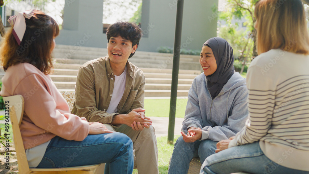 © tirachard - Small Asian group of people sit in a close circle and talk to a therapist in park. Smile people sharing story happy speak diverse people sitting in circle at group therapy session with psychologist. © tirachard - Small Asian group of people sit in a close circle and talk to a therapist in park. Smile people sharing story happy speak diverse people sitting in circle at group therapy session with psychologist.