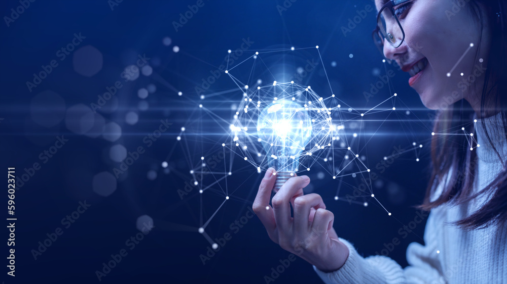 Businesswoman holding a light bulb illuminates the connection of polygons on the internet network. Futuristic technology on blue background Inspire to find innovation and develop marketing strategies. Businesswoman holding a light bulb illuminates the connection of polygons on the internet network. Futuristic technology on blue background Inspire to find innovation and develop marketing strategies.