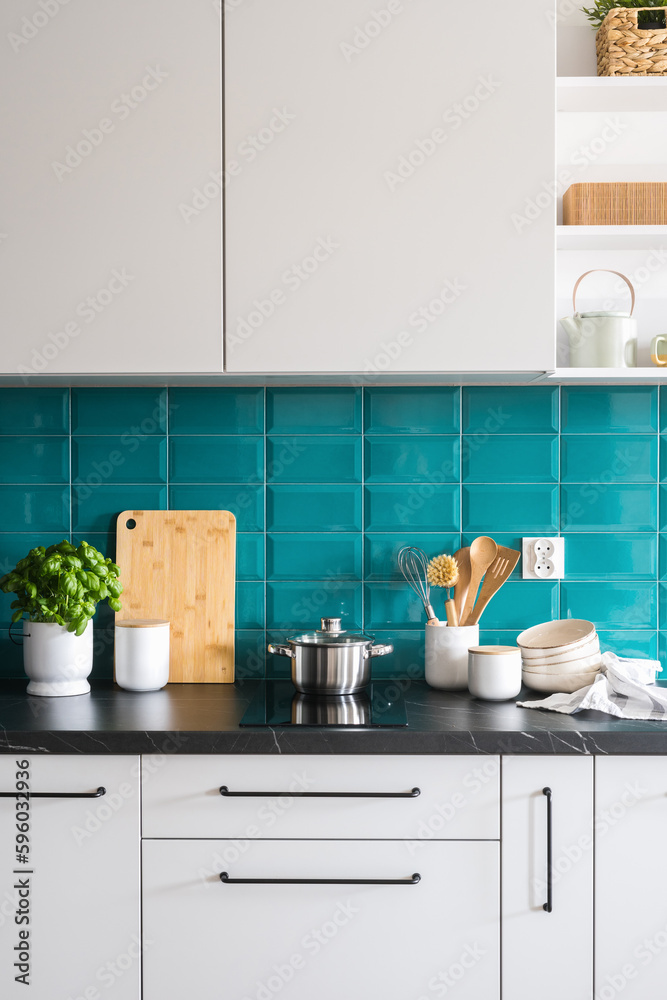 induction hob, saucepan, utensils and kitchenware on modern kitchen induction hob, saucepan, utensils and kitchenware on modern kitchen