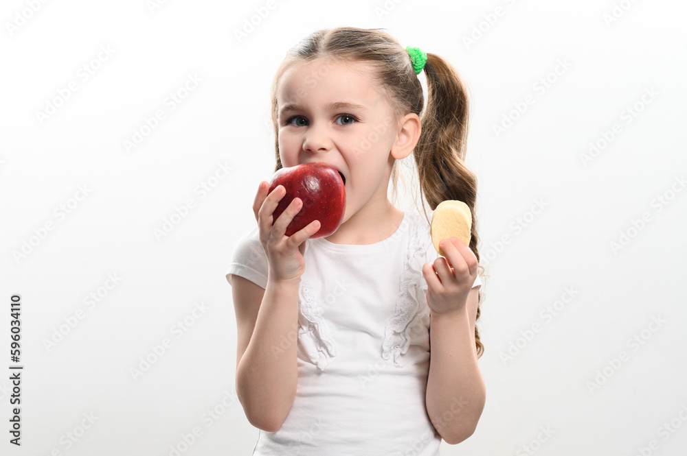 Red apple and potato chips, healthy and unhealthy food for children, little girl makes a choice between healthy and unhealthy. Red apple and potato chips, healthy and unhealthy food for children, little girl makes a choice between healthy and unhealthy.