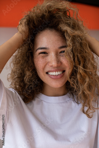 Attractive curly woman with freckles.