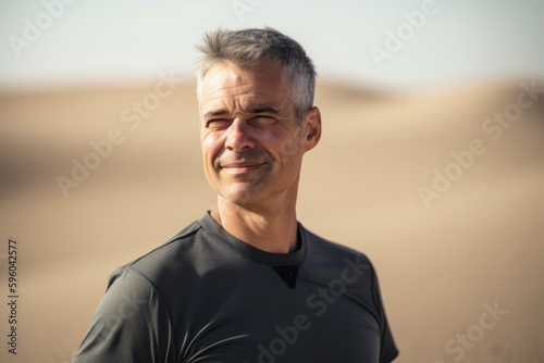 Portrait of a middle-aged man standing in the desert.