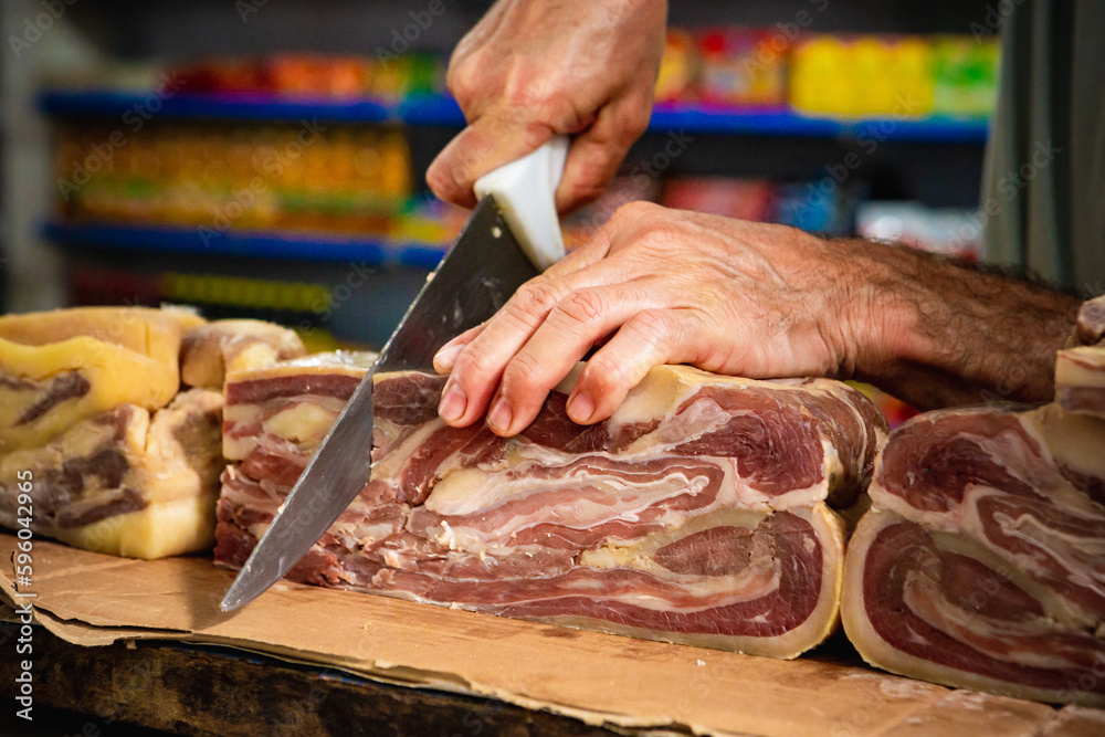 Man cutting beef jerky at market | Brazillian tipical food