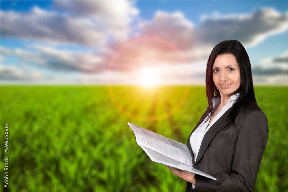 Fototapeta premium Female young assistant on the big field in work