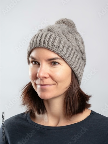 Portrait of a beautiful young woman in a gray knitted hat