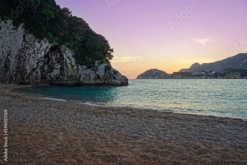 Rovinia beach during sunset. Corfu Island - Greece. Amazing colours including purple, orange and turquoise Ionian Sea. 