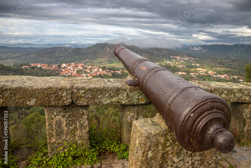 Beautiful Exposure of the old canon from the Viewpoint of Monsanto village in Portugal, considered the "most Portuguese village in Portugal". Taken on a rainy day with lovely clouds.