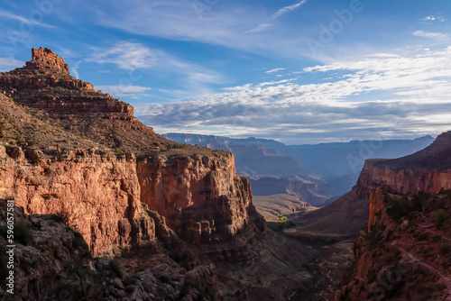 Panoramic aerial view from Bright Angel hiking trail at South Rim of Grand Canyon National Park  Arizona  USA. Vista after sunrise in summer. Colorado River weaving through valleys and rugged terrain