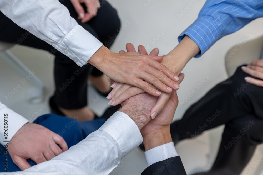 Close up of people holding hands during therapy session Close up of people holding hands during therapy session