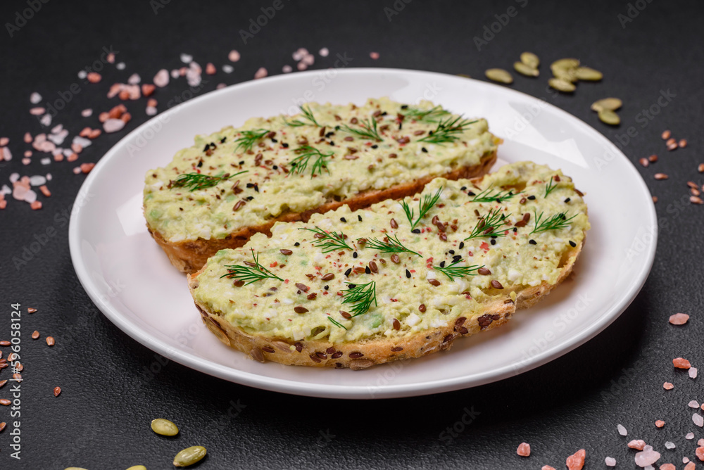 Grilled toast with avocado paste, eggs, cream cheese, salt, spices and herbs Grilled toast with avocado paste, eggs, cream cheese, salt, spices and herbs