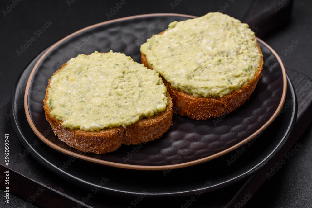 Grilled toast with avocado paste, eggs, cream cheese, salt, spices and herbs Grilled toast with avocado paste, eggs, cream cheese, salt, spices and herbs