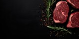 raw beef steak with herbs, free space on text on black background