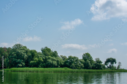 Big river Oskol in the east of Ukraine. Beautiful landscape of the river against the backdrop of the forest and blue sky.