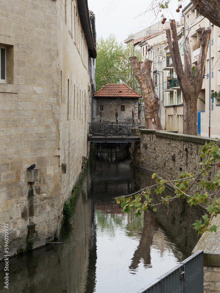 Old canal in iconic rue des Teinturiers, in Avignon, France, built in the middle ages for the textile industry Old canal in iconic rue des Teinturiers, in Avignon, France, built in the middle ages for the textile industry
