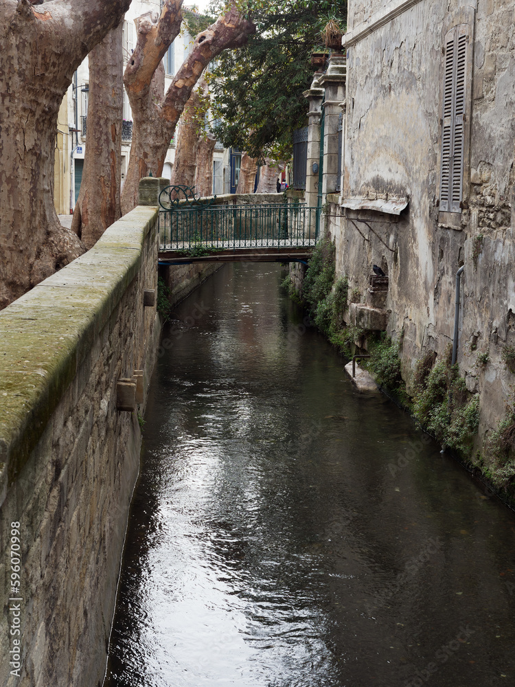 Old canal in iconic rue des Teinturiers, in Avignon, France, built in the middle ages for the textile industry