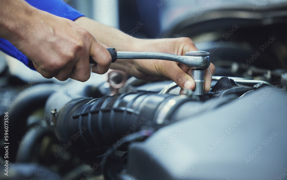Nice and tight. an unrecognizable male mechanic working on the engine of a car during a service.
