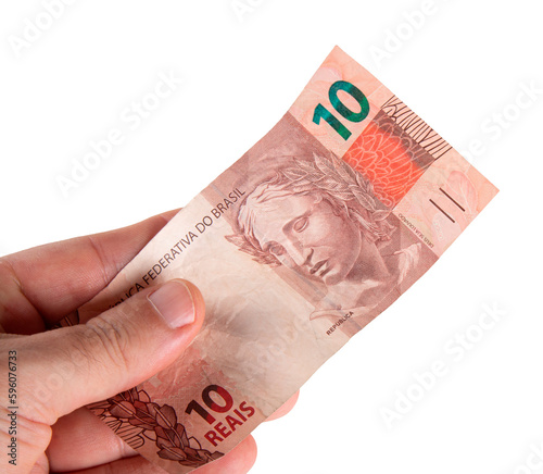 Hand holding Brazilian ten reais banknote. png transparent background photo