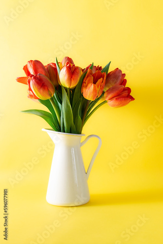 Wallpaper Mural Beautiful bouquet of tulips in white jug on bright yellow background close up. Torontodigital.ca