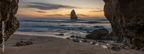 Eroded cliffs and sea stacks of sandstone-limestone frame the south and north sections of Praia do Camilo Beach, Lagos-Algarve-Portugal. photo