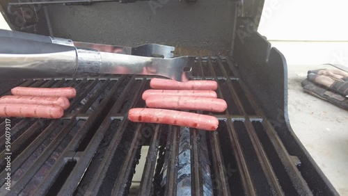 Grilling weiners on the bbq photo