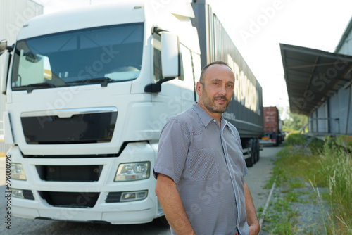handsome driver near big modern truck outdoors