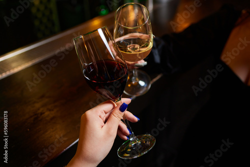 Clinking glasses with alcohol and toasting, party.