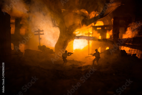 War Concept. Battle scene on war fog sky background, Fighting silhouettes Below Cloudy Skyline at night. City destroyed by war