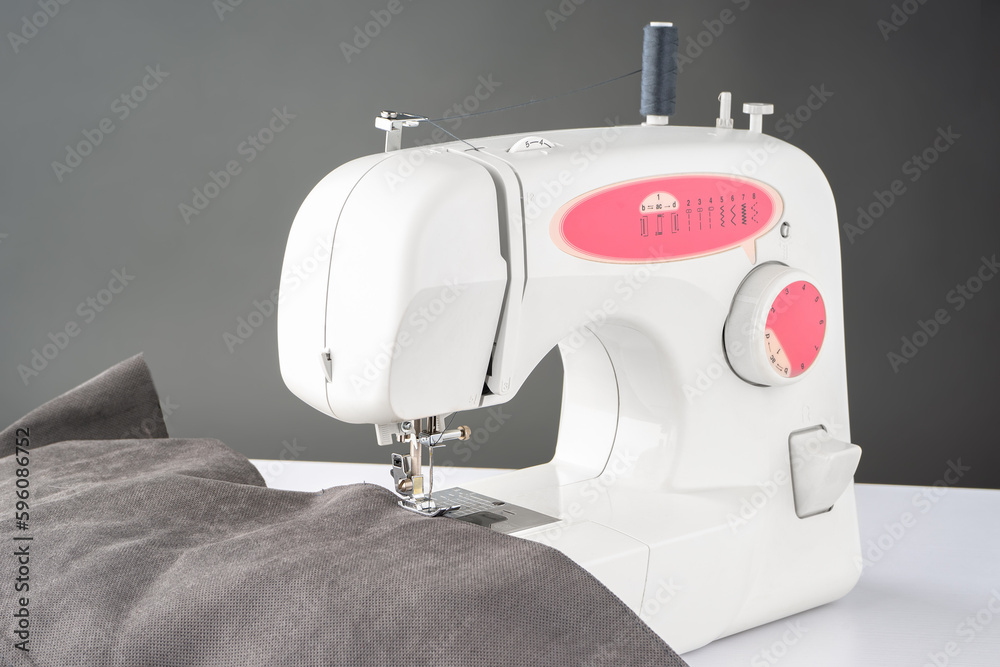 Modern sewing machine with gray fabric