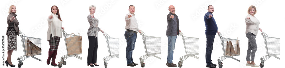 a group of people with a shopping cart point their finger at the camera a group of people with a shopping cart point their finger at the camera