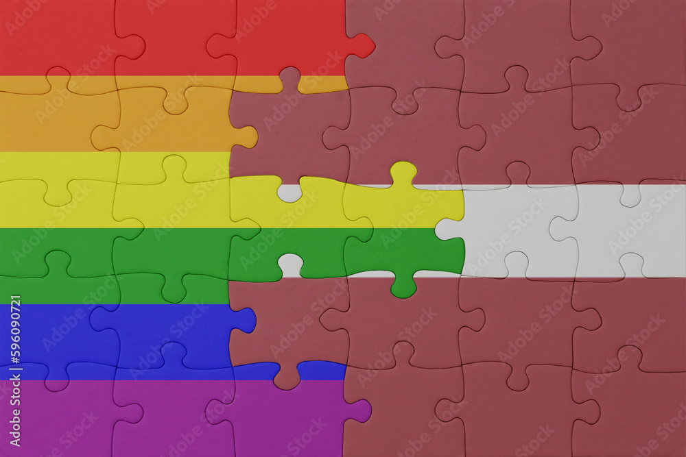 puzzle with the flag of rainbow gay pride and latvia . macro.concept. puzzle with the flag of rainbow gay pride and latvia . macro.concept.